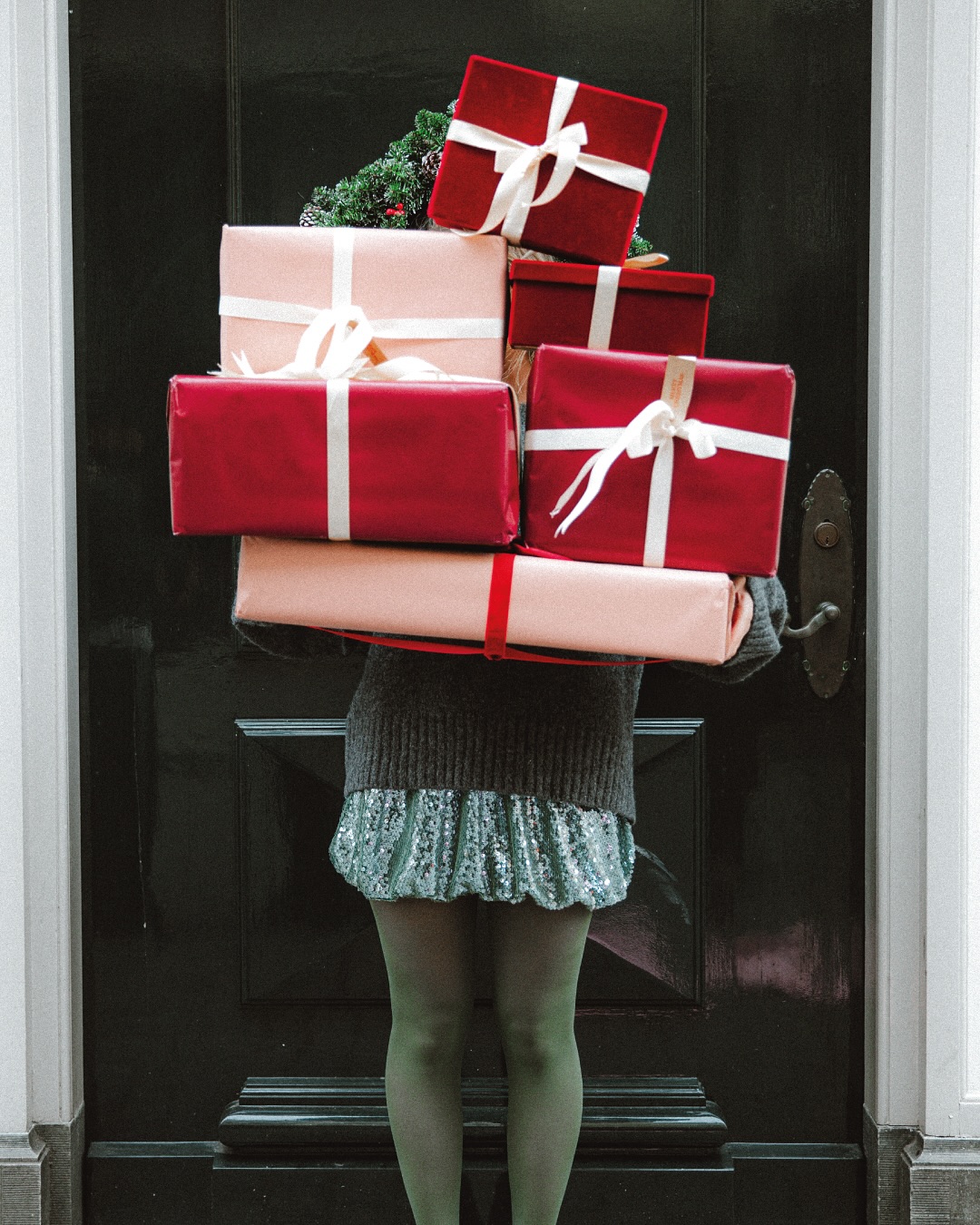 Ženska, ki v roki drži božična darila