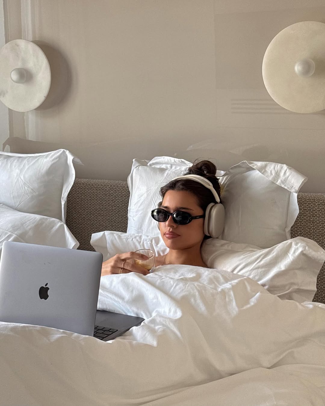 Ženska s slušalkami z odpravljanjem hrupa v postelji