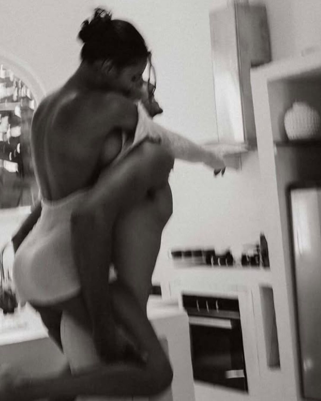 Par, črno bela fotka, moški jo nosi na hrbtu